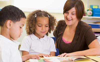 Woman teacher with two schoolchildren